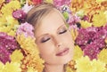 Feeling floral. A young woman posing with her eyes shut and flowers in her hair. Royalty Free Stock Photo