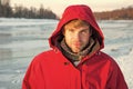 Feeling frosty. man enjoy snowy landscape in sunset. travel and expedition concept. man in red parka. winter male Royalty Free Stock Photo