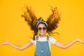 Feeling good fabulous hair. Adorable girl with curly hair waving on yellow background. Little hair model with fashion