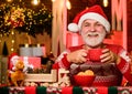 Feeling good at home. Senior man Santa claus drinking tea. New year celebration. Hot beverage. Christmas cocoa recipe