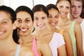 Feeling great after yoga class. Portrait of a positive-looking group of yoga students standing in a row and smiling at