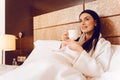 Delighted woman relaxing at hotel room