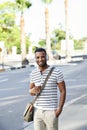 Feeling at home in the city. A handsome african american businessman standing the city while listening to some music. Royalty Free Stock Photo