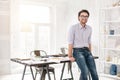 Alert businessman standing near the table