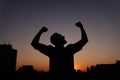 Feeling like a winner or happiness silhouette man at sunset Royalty Free Stock Photo