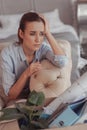 Portrait of disappointed woman propping her head with hand