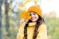 Feeling the nature. knitwear warm you in any weather. girl in yellow sweater and hat. kid enjoy nature in autumn park Royalty Free Stock Photo