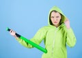 Feeling power. Woman play baseball game or going to beat someone. Girl hooded jacket hold baseball bat blue background