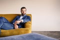 Feeling relaxed...Handsome and well-dressed businessman is resting on sofa and thinking about business Royalty Free Stock Photo