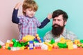 Feeling safe with dad. small boy with dad playing together. father and son play game. building home with colorful Royalty Free Stock Photo