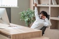 Dark-haired businessman feeling sleepy and stretching