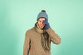 Feeling sorry. Man handsome unshaven guy wear winter accessories on blue background. Winter season sale. Hipster knitted Royalty Free Stock Photo