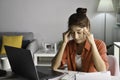 Feeling tired and stressed. Young Asian woman sitting with eyes closed from exhaustion and tiredness during working at home office Royalty Free Stock Photo