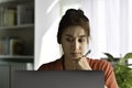 Feeling tired and stressed. Young Asian woman sitting looking deep in thought exhausted and tired during working at home office us Royalty Free Stock Photo