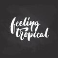 Feeling tropical - hand drawn Summer seasons holiday lettering phrase isolated on the white background. Fun brush ink