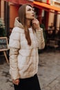 Feeling warm and protected. european winter. girl warm coat stairs background. faux fur coat fashion. stylish business lady