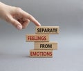 Feelings and Emotions symbol. Concept word Separate Feelings from Emotions on wooden blocks. Beautiful grey background. Doctor