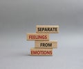 Feelings and Emotions symbol. Concept word Separate Feelings from Emotions on wooden blocks. Beautiful grey background. Psychology