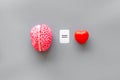 Feelings and mind concept with brain equals to heart on gray background top view mock up