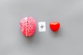Feelings and mind concept with brain plus heart on gray background top view