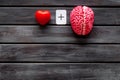 Feelings and mind concept with brain plus heart on wooden background top view mock up Royalty Free Stock Photo