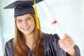 Feels so good to have it in my hands. A pretty college student in her graduation gown showing you her degree. Royalty Free Stock Photo