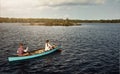 Feels great to be away from the city. a young couple rowing a boat out on the lake.