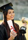 Feels great to be recognized as a top achiever. Portrait of a student holding her diploma and trophy on graduation day. Royalty Free Stock Photo