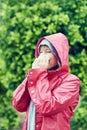 It feels great to blow my nose. a young woman blowing her nose with a tissue outdoors. Royalty Free Stock Photo