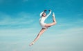 Feels like flying. Young ballerina jumping on blue sky. Pretty girl in dance wear. Cute ballet dancer. Concert Royalty Free Stock Photo