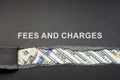 Fees and charges concept. Inscription and a torn piece of paper. Royalty Free Stock Photo