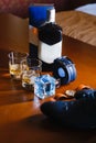 Men`s shoes, a belt rolled up by a ring, watches, cologne, a bottle of alcohol, two glasses with alcohol and an Royalty Free Stock Photo