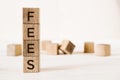 Fees word written on wooden cubes on light background with copy space Royalty Free Stock Photo