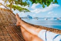 Feet of adult woman relaxing in a hammock on the beach during summer holiday in El nido, Palawan, Philippines Royalty Free Stock Photo