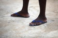 Feet of an African man in blue flip flops Royalty Free Stock Photo