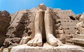 Feet of an ancient statue of Pharaoh in the Karnak temple in Luxor Royalty Free Stock Photo