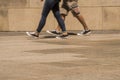 Feet of anonymous couple walking along a pavement