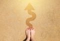 Feet and arrow sign go straight on sea beach background. Top view of woman and barefoot. Selfie foot and legs with red manicure Royalty Free Stock Photo