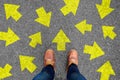 Feet and arrows on road background. Taking decisions for the future with many arrows choices, left right or move forward. Hipster