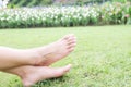 Feet of asian woman relaxing on grass field Royalty Free Stock Photo