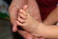 feet of baby in mother hand