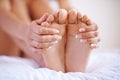 Feet, beauty spa and pedicure or manicure on nails of a woman on home bed for luxury skincare. Toes and hands of Royalty Free Stock Photo