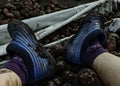 Feet in blue galoshes. Potato harvesting. Autumn potato harvest