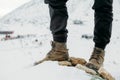 Feet in boots on a background of snowy mountains after a long walk Royalty Free Stock Photo