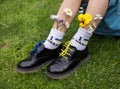 Feet of boy in black patent leather shoes and socks with inscription I love Ukraine, standing on green grass Royalty Free Stock Photo