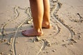 Feet of a boy is painting figures