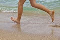 Feet of boy running along the beach Royalty Free Stock Photo