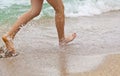 Feet of boy running along the beach Royalty Free Stock Photo