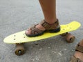 Feet of a boy on a skateboard. Royalty Free Stock Photo