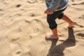 Feet of boy walking on the sand of the beach Royalty Free Stock Photo